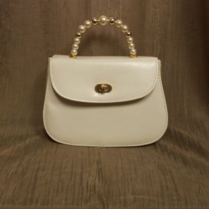 Small White leather purse with faux pearl handle.